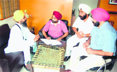 Baba Kulwant Singh holds a meeting with District Tourism Officer Balraj Singh in Amritsar on Monday. 
