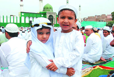 Children exchange greetings on Eid-ul-Fitr in Bathinda on Monday. 