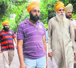 ACP Adarshdeep Singh (centre), his father Gurmeet Singh (right) and brother Gagandeep Singh come out of a court on Monday. 