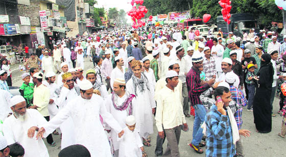 Devotees come out of Idgah after offering prayers; brothers hug each other; and a father celebrates the occasion with his son in Dehradun on Monday.