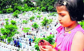 A girl offers naamaz on the occasion of Eid-ul-Fitr in Haridwar on Monday.
