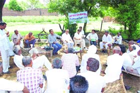 Farmers participating in a seminar at Nahar village in Rewari district