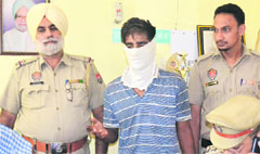 Harwinder, who murdered his wife, in police custody in Shahkot on Monday. 