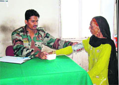 A doctor examines a patient at a free medical camp at Tain in Mendhar. 