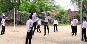 Students play volleyball at a school in Ludhiana.