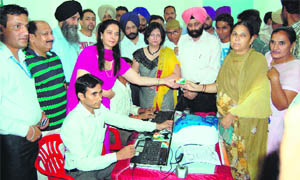 Chief Parliamentary Secretary Dr Navjot Kaur Sidhu distributes Rashtriya Swasthya Bima Yojana cards at a government hospital at Verka on Tuesday. 
