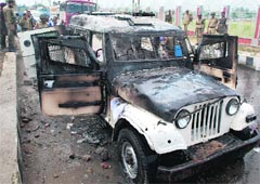 The police vehicle which was set ablaze by a mob in Srinagar on Monday. Photo: Yawar Kabli