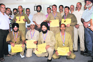 Employees of the SRTC with their medals at the SRTC office in Jammu on Tuesday.