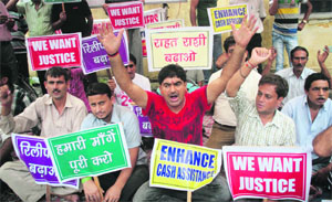 Kashmiri Pandits stage aprotest outside the Relief Commissioners office in Jammu on Tuesday. 