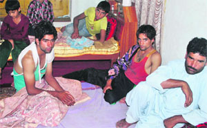 Lateef Ahmad of Adipora, who survived the road accident at Pahalgam, at his home with his family.