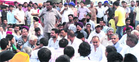 Residents block National Highway No 703 after some assailants attacked a restuarant owner and his three sons.