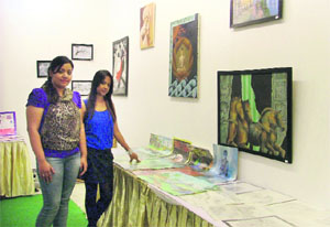 Artist Ayushi Gupta (second from left) at her art and craft exhibition at an art gallery in Ludhiana on Tuesday