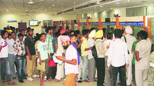 Applicants line-up outside the new licensing window opened at the Hall No. 3 of Suvidha Centre in Ludhiana on Tuesday. 