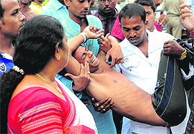 An injured being carried to a hospital after the connecting rope of a swirl ride snapped at an amusement park in Kolkata on Tuesday. 