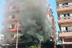Smoke billows from a building in the Bab al-Tabbaneh neighbourhood of Tripoli following clashes between pro and anti-Syrian regime supporters on Tuesday.