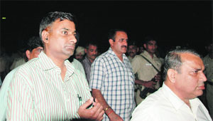 CTU GM SP Parmar (extreme right) is escorted by the police at his office in Chandigarh on Wednesday.