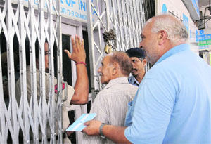 Unaware of the two-day bank strike, customers visit a branch of the State Bank of India in Chandigarh on Wednesday.