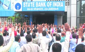 Members of the United Forum of Bank Unions hold a protest in Jalandhar on Wednesday