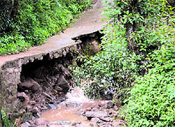 A road damaged by heavy rain at Boon Badi village