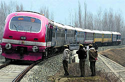 CRPF personnel stand guard near a railway track at Nowgam, 12 km from Srinagar