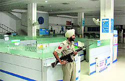 A guard keeps vigil at a deserted bank following a two-day strike call by employees in Ludhiana on Wednesday