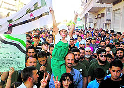 Demonstrators protest against the Syrian President in Sermada near Idlib