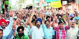 Members of the Punjab Bank Employees Federation protest during the All-India bank strike near Town Hall in Amritsar on Thursday