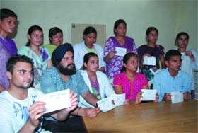 Protesting BDS students of Adesh Dental College show the reciepts issued by the college, during a press conference at the Teachers Home in Bathinda on Thursday