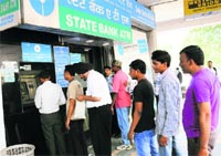 People line up outside an ATM booth to withdraw cash at Sector 17 in Chandigarh on Thursday. Tribune photo: Manoj Mahajan 