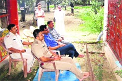 Officials hold talks with Matra Sadan founder Swami Shivanand (Behind the iron railing) at Matra Sadan ashram, Jagjeetpur, in Haridwar on Friday. Tribune photo: Rameshwar Gaur