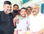Uttarakhand Sports Minister Dinesh Aggarwal felicitates Prem Kumar for winning two medals in the national para badminton championship held at Bangalore recently.