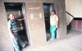 MC employees open lifts for the VIP visitors during the function at Nehru Garden in Jalandhar on Thursday