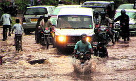 People move in a water-logged street after heavy rain in Jodhpur on Thursday.