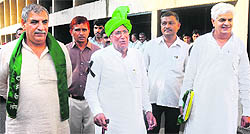 INLD chief Om Prakash Chautala and other MLAs come out of the Assembly in Chandigarh after staging a walkout on Friday