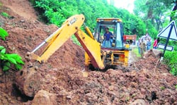 PWD workers clear the road near the education board office in Dharamsala on Friday. Photo: Kamaljeet