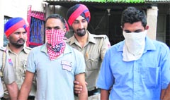 The accused in police custody in Jalandhar on Friday. A Tribune photograph