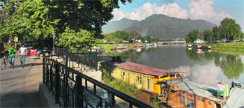 Cyclists take a stroll on the Residency Road along the Jhelum in Srinagar. The river, also called Vyeth, traverses a distance of around 190 km from Verinag to Baramulla.