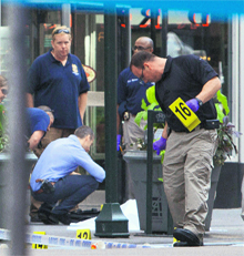Police officials stand near the covered body of the suspected shooter near the Empire State Building in New York on Friday.