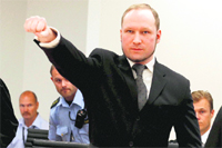 Mass murderer Anders Behring Breivik salutes after he arrives at the court room in Oslo on Friday.