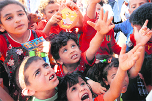 Syrian refugee children receive toys and other goodies distributed at the Zaatari refugee camp close to the Jordanian city of Mafraq.