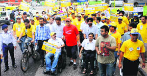 Volunteers participate in a walkathon for road safety at the Sector-17 Plaza in Chandigarh on Saturday. 