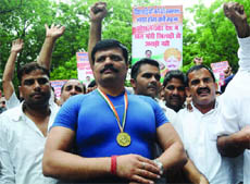 Asian Gold medallist Kunwar Pranav Singh with his supporters durng a protest In New Delhi on Saturday.