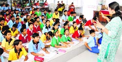 Sanjana Kapoor from the Amar Chitra Katha magazine interacts with children at Jaswant Modern School in Dehradun on Saturday as part of the Ghummakkad Narain-Travelling Literature Festival. Tribune photo: Vinod Pundir. 