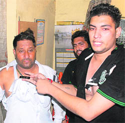With torn clothes, two Punjab Police personnel argue inside a police booth at PAP Chowk in Jalandhar on Saturday. 