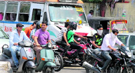 Throwing norms to the wind, two-wheeler drivers are seen without helmets.