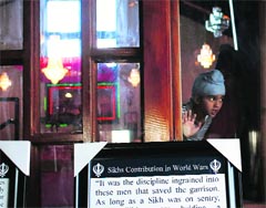A young Sikh child looks out during an ardas at the Sikh Religious Society of Wisconsin for the victims of the shooting at the gurdwara at WisconsinPhoto: AFP