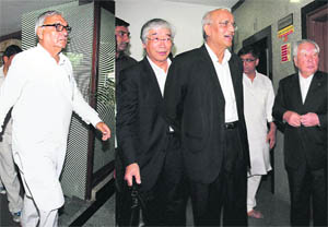 Haryana Chief Minister Bhupinder Singh Hooda and Suzuki Motor chairman Osamu Suzuki arrive for a meeting at the Haryana Bhawan, New Delhi, on Sunday. 