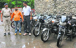 The accused (centre) in police custody along with recovered vehicles at the Sector 17 police station in Chandigarh on Sunday