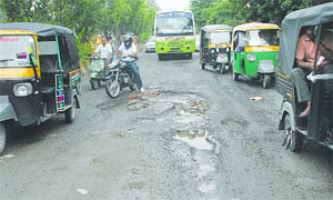 Potholes surface on Rama Mandi-BSF Chowk stretch in Jalandhar. 