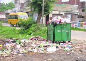 A dustbin overflows with garbage in the Passi Nagar area of Ludhiana